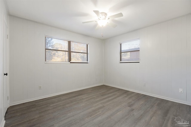 unfurnished room with ceiling fan and dark hardwood / wood-style flooring