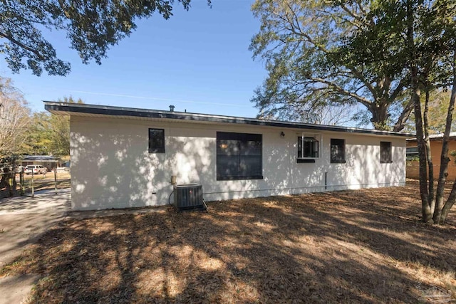 rear view of property with central AC unit