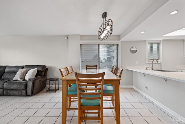 dining space featuring baseboards, light tile patterned flooring, and recessed lighting