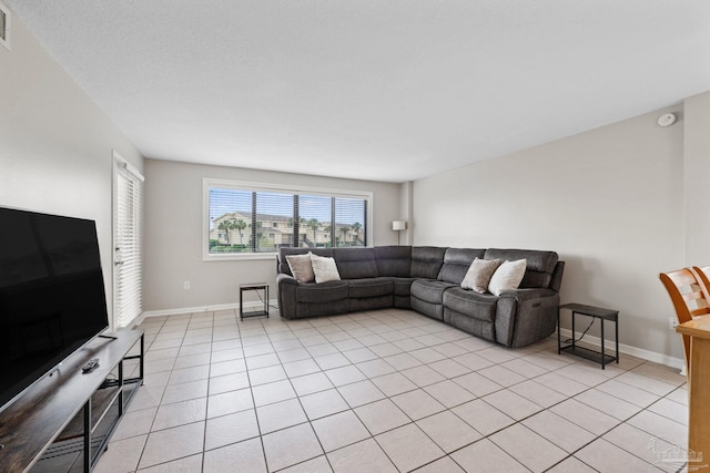 living area with light tile patterned floors and baseboards