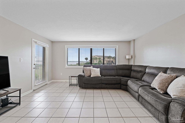 living area with light tile patterned floors and baseboards