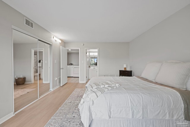 bedroom featuring light wood-type flooring, ensuite bathroom, and baseboards
