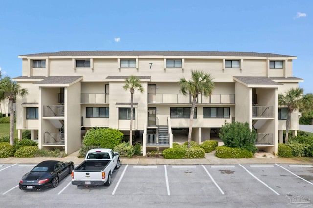 view of apartment building / complex featuring uncovered parking