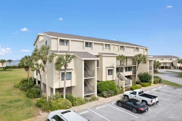 view of building exterior with uncovered parking