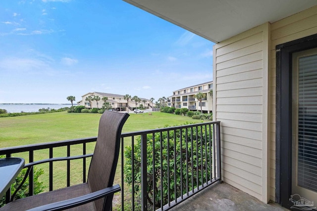 balcony with a water view and a residential view