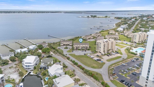 aerial overview of property's location featuring a large body of water and apartment complex / building