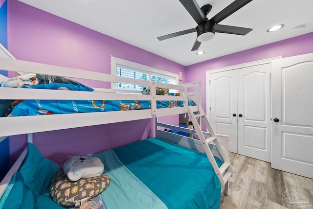 bedroom featuring a ceiling fan, recessed lighting, wood finished floors, and a closet