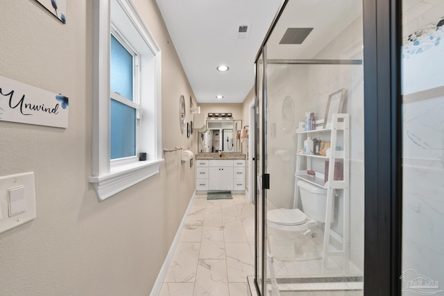 bathroom with vanity, a shower stall, baseboards, and marble finish floor