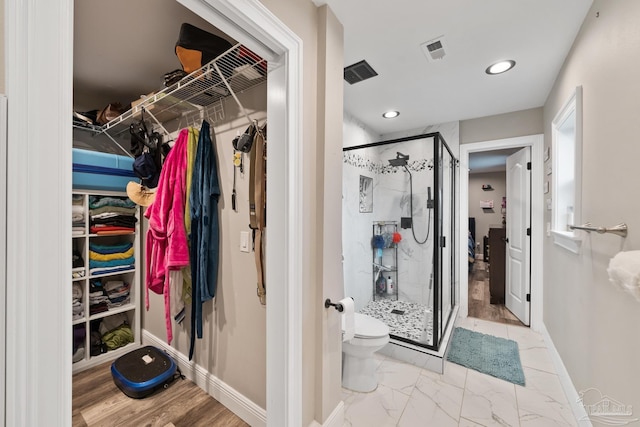 walk in closet with visible vents and marble finish floor