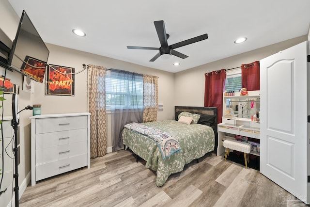 bedroom with recessed lighting, multiple windows, and light wood-style flooring