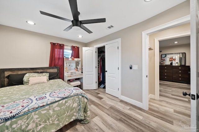 bedroom with light wood finished floors, visible vents, baseboards, recessed lighting, and a closet