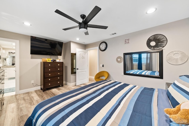 bedroom featuring visible vents, ensuite bathroom, wood finished floors, recessed lighting, and baseboards