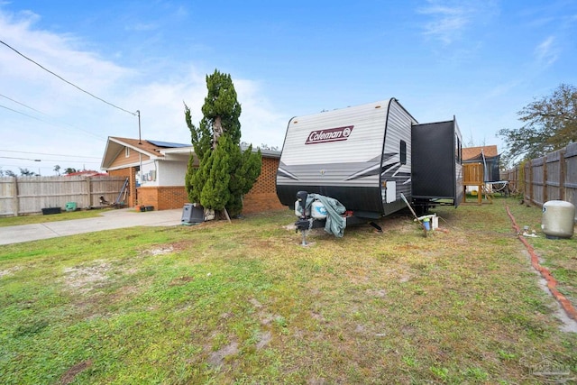 view of yard featuring a trampoline and fence