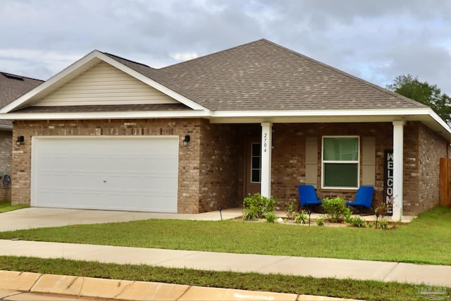 view of front of property with a garage, a front yard, and a porch