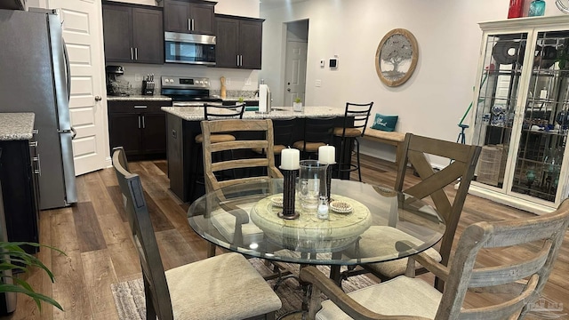 dining area with sink and dark hardwood / wood-style flooring