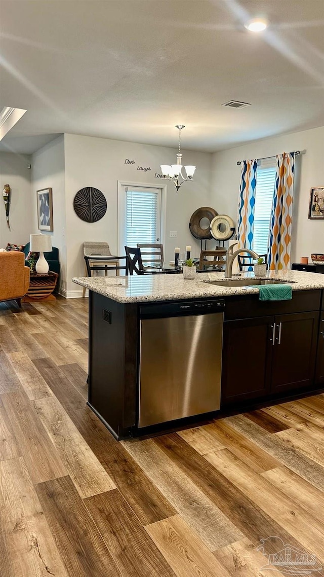 kitchen with dishwasher, light hardwood / wood-style flooring, a notable chandelier, and hanging light fixtures