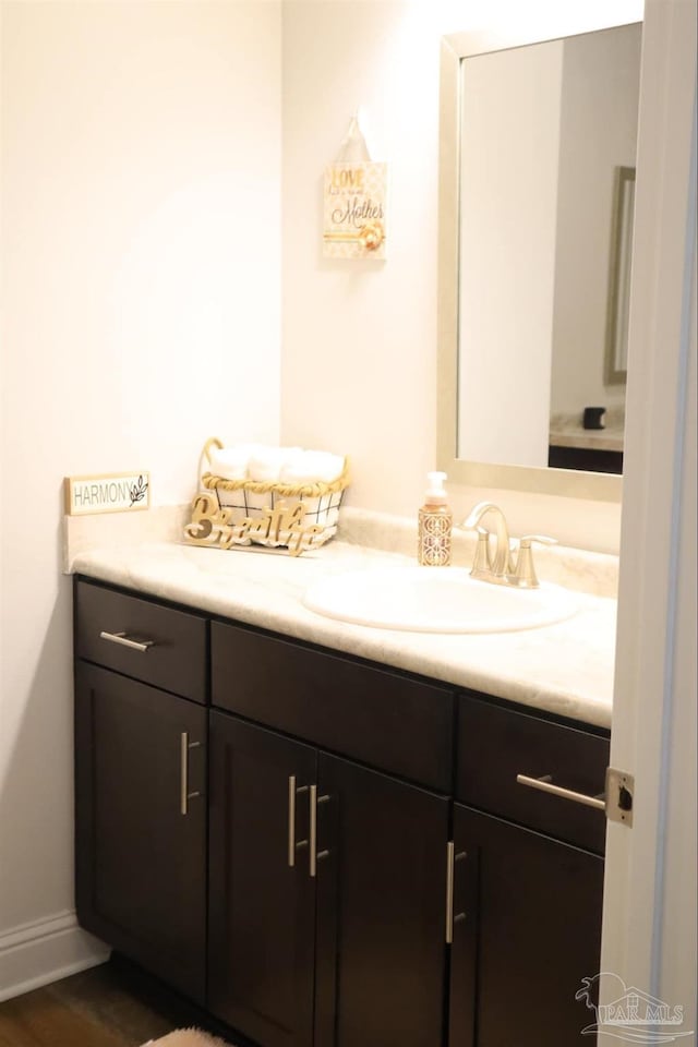 bathroom featuring hardwood / wood-style flooring and vanity