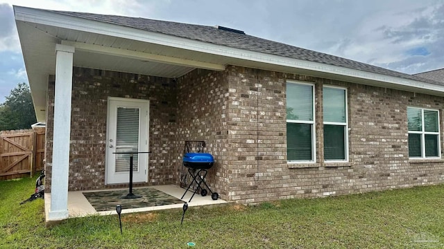 rear view of house with a yard and a patio