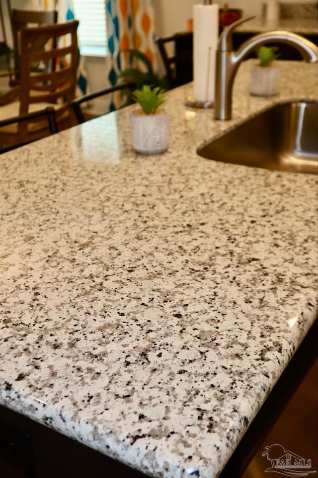 details featuring sink and light stone countertops