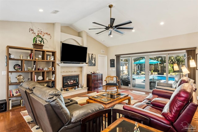 living room with hardwood / wood-style floors, french doors, ceiling fan, and lofted ceiling