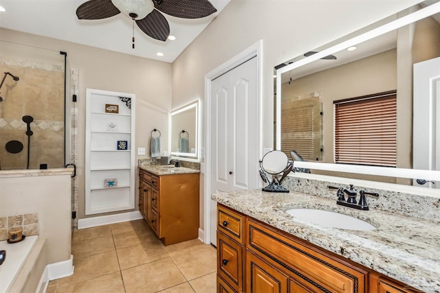 bathroom featuring tile patterned floors, ceiling fan, vanity, and plus walk in shower