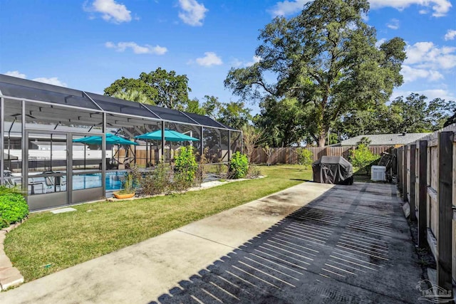 view of patio featuring area for grilling, a lanai, and a fenced in pool