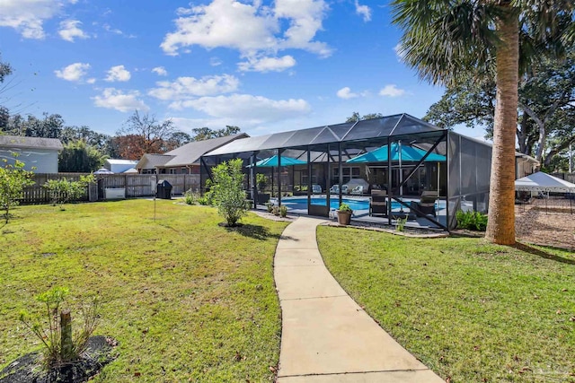 view of yard with a lanai and a fenced in pool