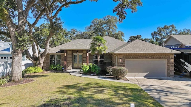 view of front of home featuring a front yard, french doors, and a garage