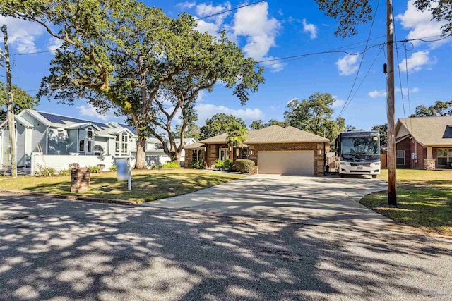 view of front of house with a front yard and a garage