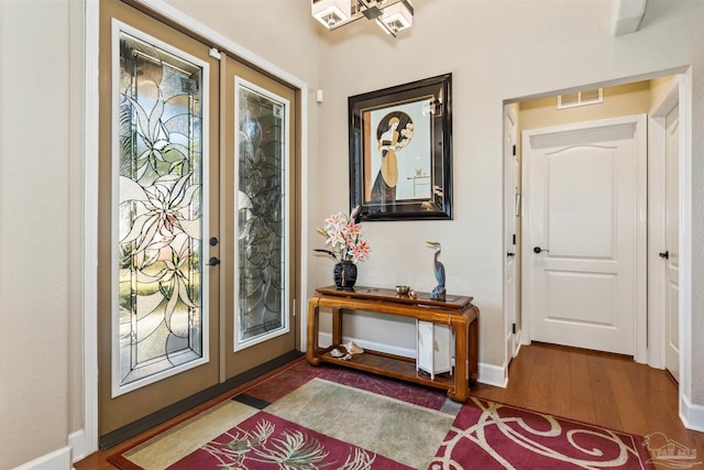 foyer entrance featuring dark hardwood / wood-style floors