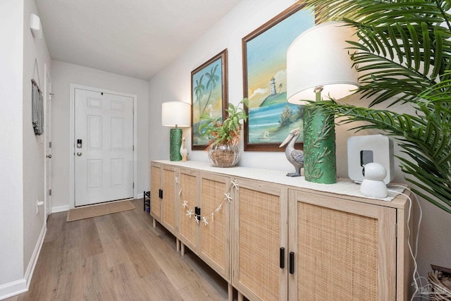 interior space featuring light wood finished floors and baseboards