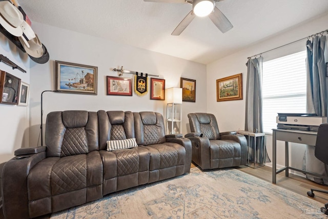 living area with ceiling fan and wood finished floors