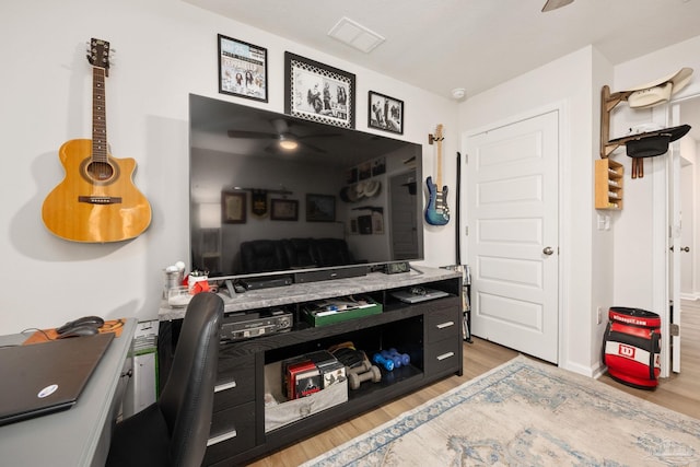 office featuring wood finished floors, visible vents, and a ceiling fan