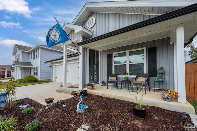 exterior space with a garage, driveway, a porch, and board and batten siding