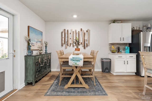 dining space with light wood finished floors, recessed lighting, and baseboards