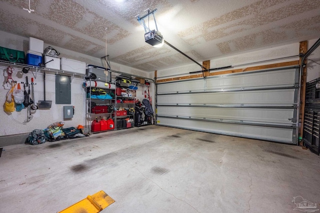 garage featuring a garage door opener and electric panel