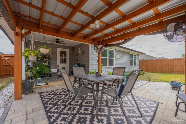 view of patio / terrace with ceiling fan, outdoor dining area, and fence