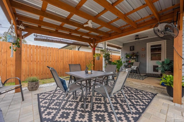 view of patio / terrace featuring outdoor dining area, fence, and a ceiling fan