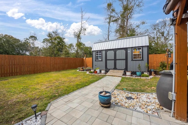 view of outdoor structure with a fenced backyard and an outbuilding