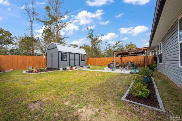 view of yard featuring an outbuilding, a vegetable garden, a patio area, a shed, and a fenced backyard