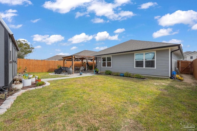 rear view of property with a fenced backyard, a shingled roof, a gazebo, a lawn, and a patio area