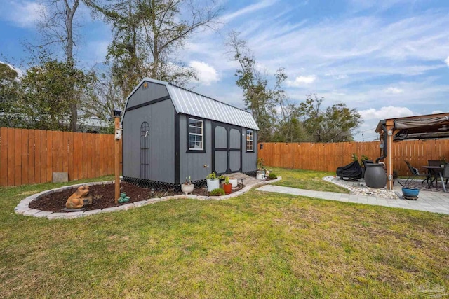 view of outdoor structure with a fenced backyard and an outbuilding