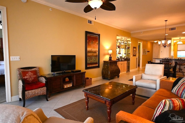 living room with ceiling fan with notable chandelier, light tile patterned floors, and crown molding