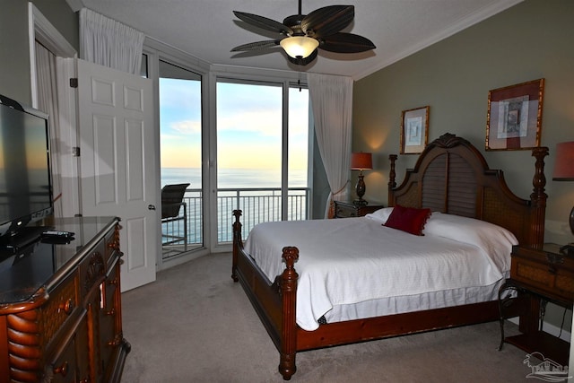 bedroom featuring light colored carpet, access to outside, ceiling fan, crown molding, and a water view