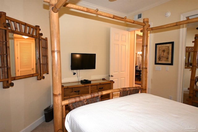 carpeted bedroom with ceiling fan and ornamental molding