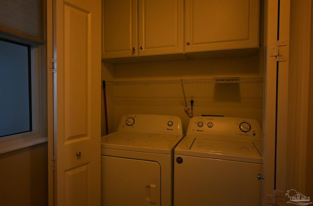 laundry area with cabinets and separate washer and dryer