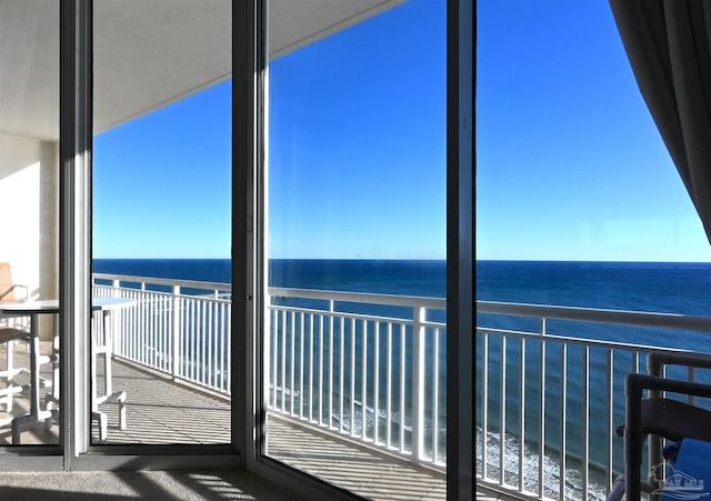 unfurnished sunroom with a water view