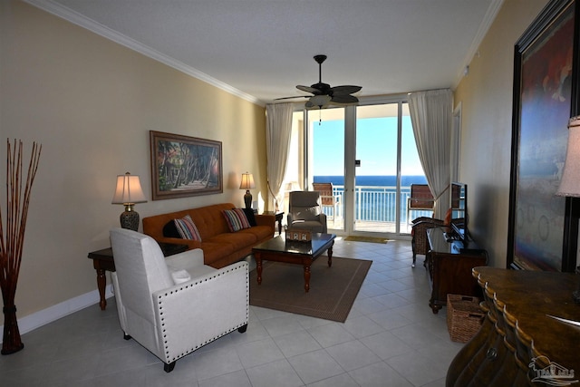 tiled living room featuring ceiling fan, expansive windows, and ornamental molding