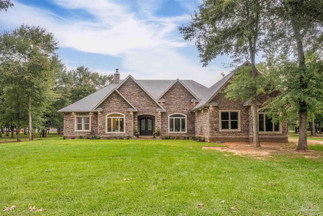 9180 Chumuckla Hwy, Pace, FL 32571 - view of front of house featuring french doors, a front lawn, a chimney, brick siding, and a shingled roof