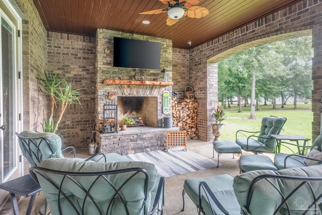 view of patio / terrace with an outdoor living space with a fireplace and ceiling fan